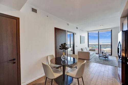 a living room with a glass table and chairs at Miami Lux 1BR 37th Floor Bay City Views in Miami