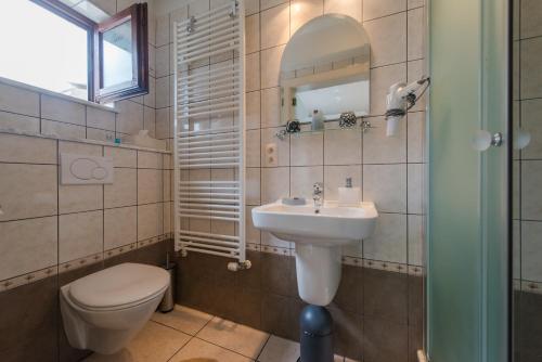 a small bathroom with a toilet and a sink at CASA ROMAN ITALIA, Center Sacile in Sacile