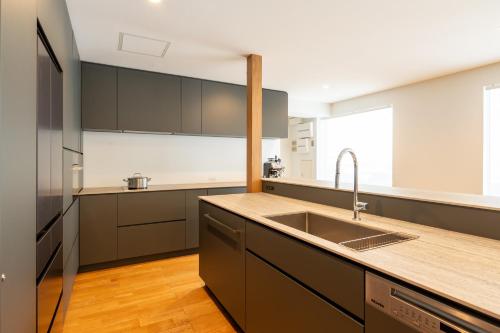 a kitchen with a sink and a counter top at Bella Vista Ski Lodge in Nozawa Onsen