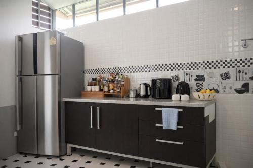 a kitchen with a stainless steel refrigerator at Grand Chalong Family House in Chalong