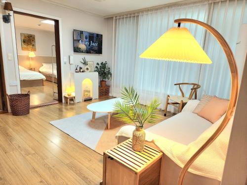 a living room with a couch and a table at 상무하우스 in Gwangju