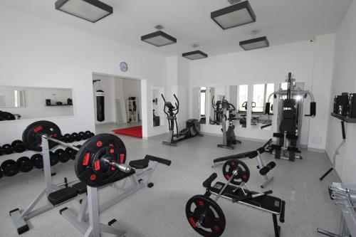 a gym with several exercise equipment in a room at Lukas Studio in Ustronie Morskie