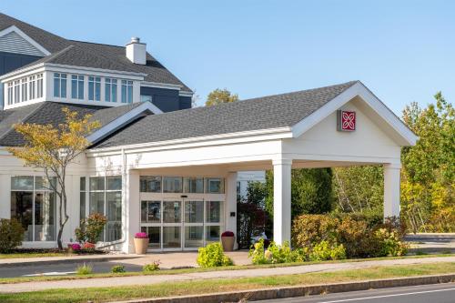 a home with a large white house at Hilton Garden Inn Portland Airport in Portland