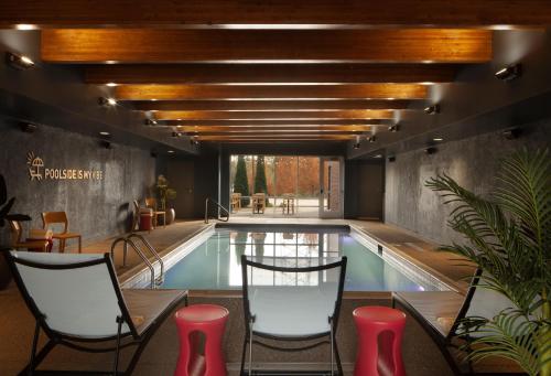 a pool with chairs and a table and a swimming pool at Home2 Suites by Hilton Canton in North Canton
