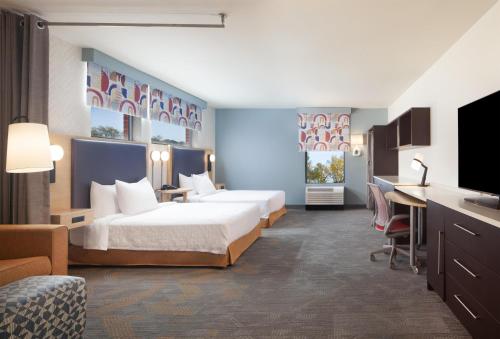 a hotel room with two beds and a desk at Home2 Suites by Hilton Canton in North Canton