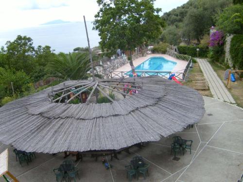 a large umbrella in front of a swimming pool at Agriturismo Castanito in Vico Equense