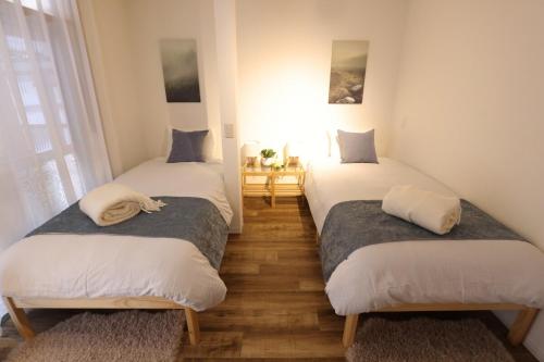 En eller flere senge i et værelse på Myoko Home