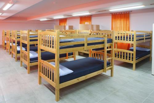 a row of bunk beds in a room at Albergue Monasterio de La Magdalena in Sarria