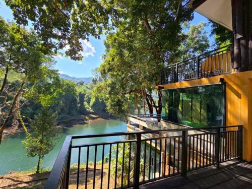 a balcony view of a river from a house at Puprai Tarnnarm Resort in Thong Pha Phum