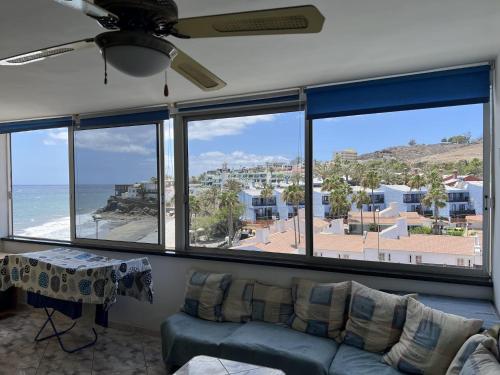 a living room with a couch and a view of the ocean at El Alba in San Bartolomé de Tirajana