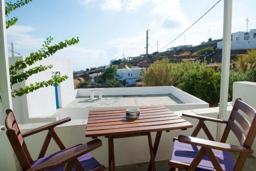 a table and chairs on a balcony with a view of a pool at Letta Studios in Apollonia