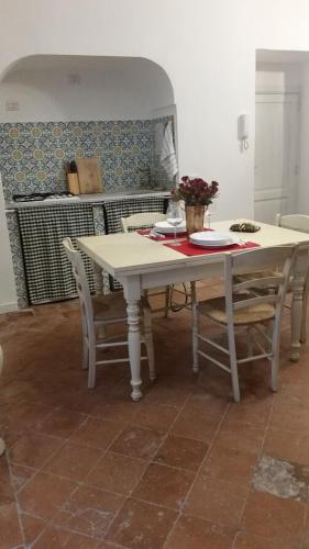 a white table and chairs in a room at La Dimora Del Professore in Naples