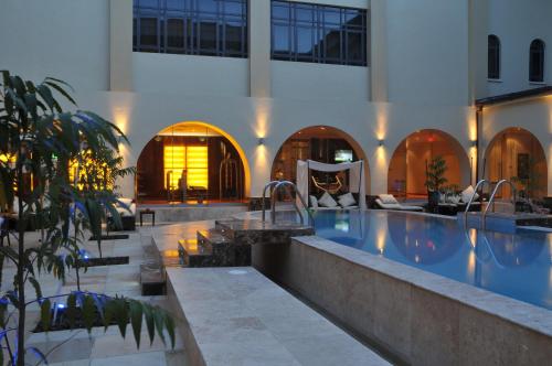 a large swimming pool in a building with a swimming pool at Radisson Lagos Ikeja in Lagos