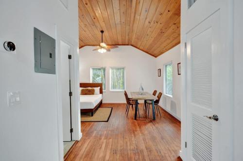 a living room with a table and a bed at Tropical Oasis Studio w Pool in Fort Lauderdale