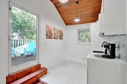 a kitchen with white walls and a window at Tropical Oasis Studio w Pool in Fort Lauderdale