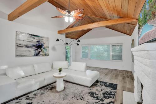 a living room with a white couch and a wooden ceiling at Tropical Oasis 2BR House w Pool in Fort Lauderdale
