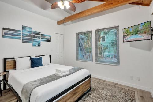 a bedroom with a bed and two windows at Tropical Oasis 2BR House w Pool in Fort Lauderdale