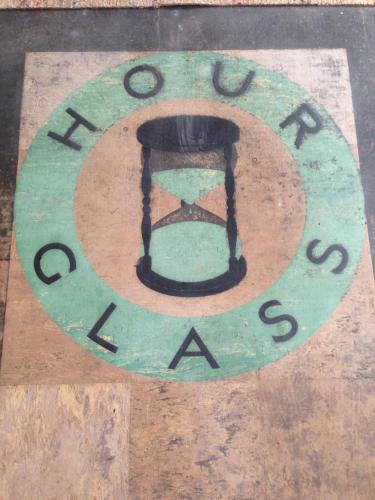 a picture of a clock on a wooden floor at Hour Glass Hotel in London
