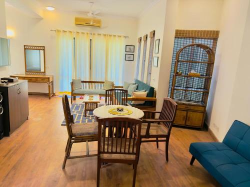 a living room with a table and chairs at Minimalist Escape in Gurgaon