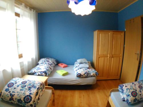 a room with two beds in the corner of a room at Noclegi Przylesie in Rychnowy