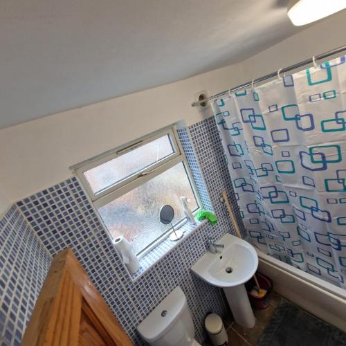 a small bathroom with a sink and a window at 4 Norman House Leicester in Leicester