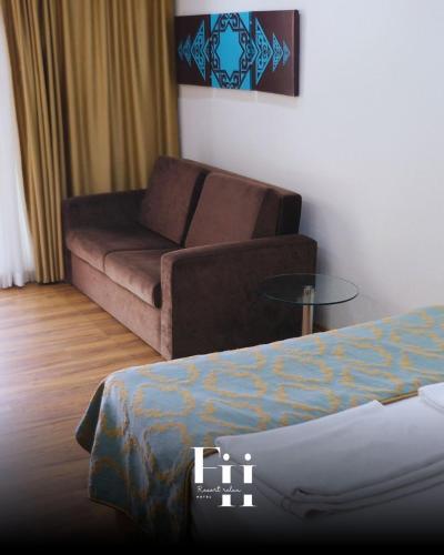 a living room with a couch and a bed at Fİi SUİTES in Kumluca
