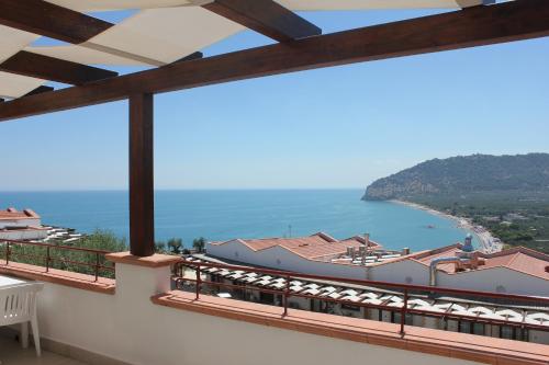 a view from the balcony of a house with the ocean at Holiday Lodge al Porto in Mattinata