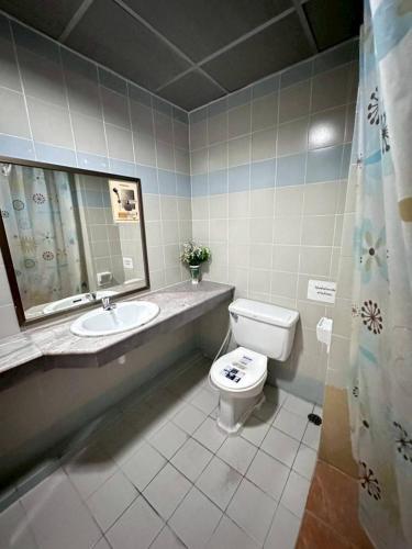 a bathroom with a toilet and a sink at ระยองบีช Rayong Beach Hotel in Ban Chak Phai