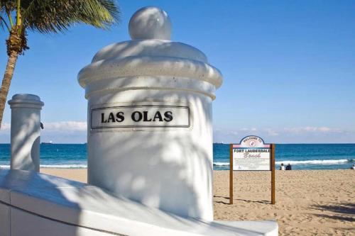 a white object on the beach with a sign at Rustic Retreats Beachy 1BR for 4 guests in the heart of Fort Lauderdale in Fort Lauderdale