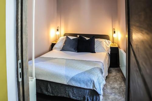 a bedroom with a bed with two pillows on it at Ospitaria-Suite Sant'Anastasia in Verona