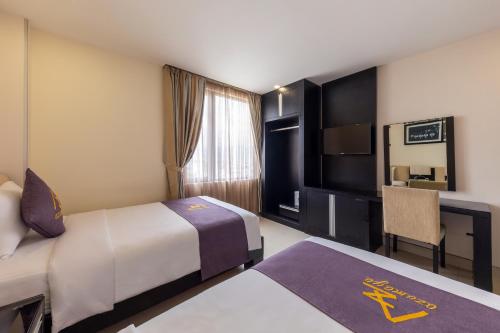 En eller flere senge i et værelse på Azumaya Hotel Da Nang