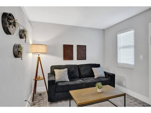 a living room with a couch and a table at Rustic Retreats Cozy 1BR For 4 Guests In The Heart Of Fort Lauderdale in Fort Lauderdale