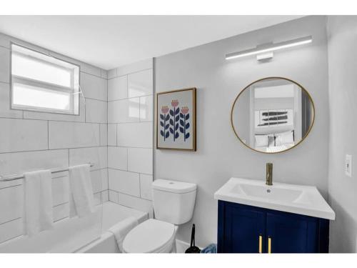 a bathroom with a sink and a toilet and a mirror at Rustic Retreats Cozy 1BR For 4 Guests In The Heart Of Fort Lauderdale in Fort Lauderdale