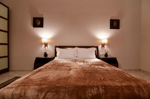 ein Schlafzimmer mit einem großen Bett mit zwei Nachttischen in der Unterkunft Kostaras Comfort Stay in Dispilio
