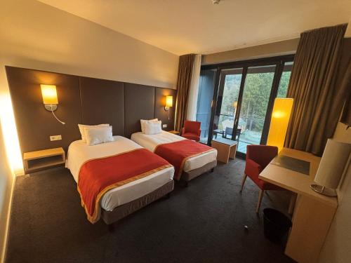 Postel nebo postele na pokoji v ubytování Hotel de la Source