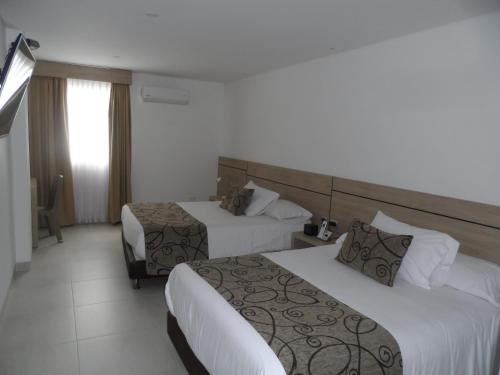 Ένα ή περισσότερα κρεβάτια σε δωμάτιο στο Hotel Arawak Plaza