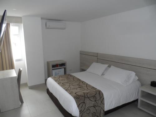 Ένα ή περισσότερα κρεβάτια σε δωμάτιο στο Hotel Arawak Plaza
