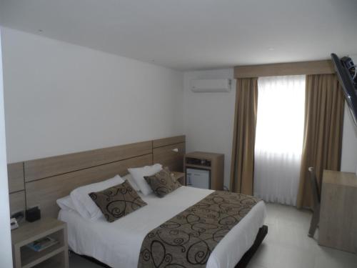 Ένα ή περισσότερα κρεβάτια σε δωμάτιο στο Hotel Arawak Plaza