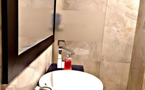 a bathroom with a white toilet in a stall at Zenith Hotel in Pipulu