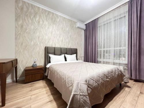 En eller flere senge i et værelse på Nexpo Premium apartaments