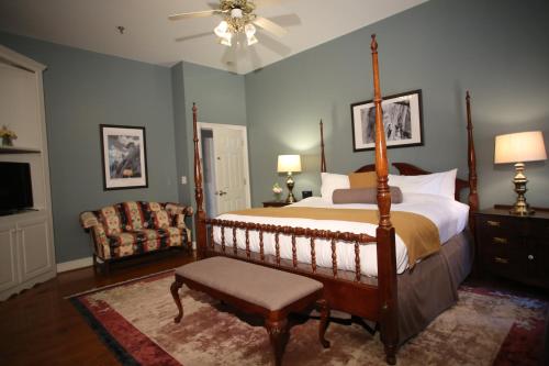 a bedroom with a bed and a chair and a fan at Stone Mountain Manor in Stone Mountain