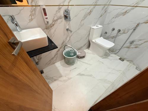 a bathroom with a sink and a toilet at Hotel Betwa sarowar in Orchha