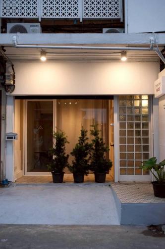 a store front with potted plants in front of it at Chatuchak Haus in Bangkok