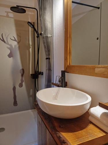 a bathroom with a white sink and a shower at Stay Novy in Bach