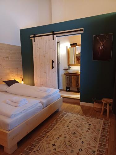 a bedroom with two beds and a green wall at Stay Novy in Bach