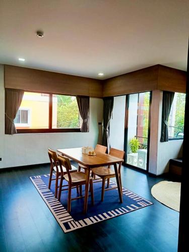 a dining room with a wooden table and chairs at Happy Hotel Aonang Krabi in Ao Nang Beach