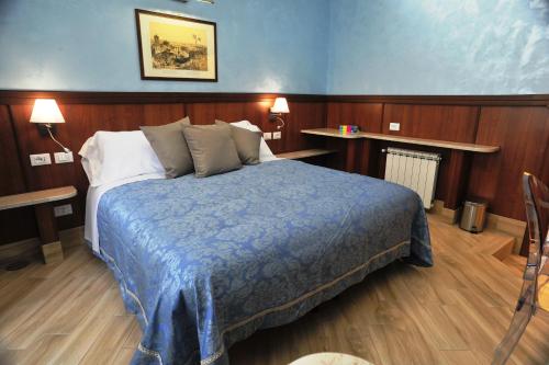 a bedroom with a bed with a blue blanket at Residenza Matteucci in Rome