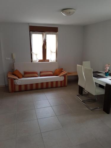 a living room with a couch and a table at Apartamentos Rurales Los Solares in Mogro
