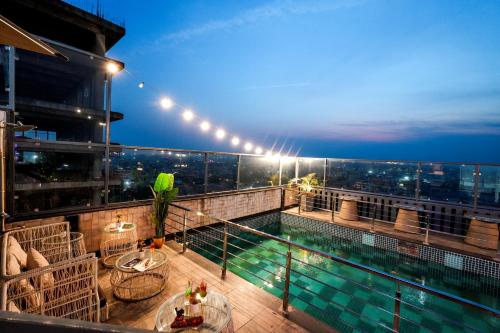 a balcony with a swimming pool on top of a building at BluSalzz Residence Amritsar in Amritsar