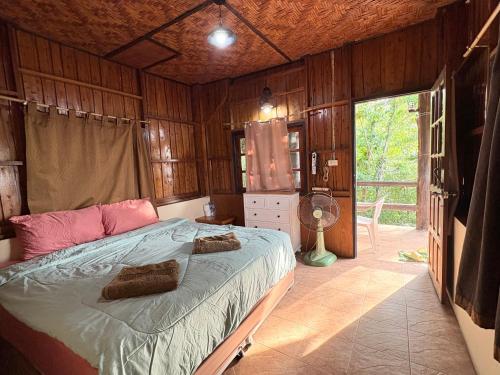 una camera da letto con un letto in una stanza con pareti in legno di Sea Rock Resort a Haad Pleayleam